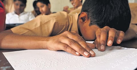 A visually impaired student reads a Braille book | Sri Loganathan Velmurugan