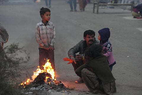 People near a bonfire during a cold and foggy winter morning, in New Delhi | PTI