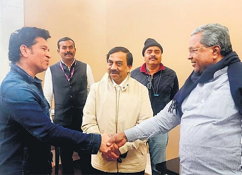 Chief Minister Siddaramaiah greets cricket legend Sachin Tendulkar at the  Delhi airport, on Thursday  | Express