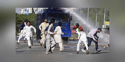Police use a water cannon to disperse supporters of Pakistan's former PM Imran Khan protesting against the arrest of their leader, in Karachi, Pakistan, Tuesday, May 9, 2023. (Photo | PTI)