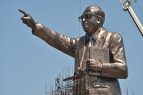 The scaffolding at the Ambedkar statue being removed by the workers at the works nears completion in Vijayawada on Friday. (Photo | Prasant Madugula)