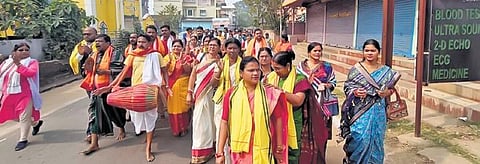 Devotees accompany the Arpan Rath to collect rice and betel nuts from people in Odisha