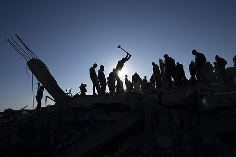 Palestinians search for bodies and survivors in the rubble of a house destroyed in an Israeli airstrike, in Rafah, southern Gaza Strip. (Photo | AP)