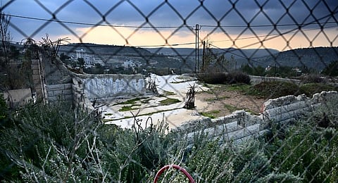 This photograph taken on December 28, 2023, shows a bulldozed house behind a fence in Al-Walaja, a Palestinian village in annexed East Jerusalem. (File Photo | AFP)