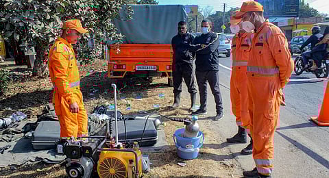 NDRF and other emergency services personnel at the site following an incident of chlorine gas leak in the Jhanjra area of Prem Nagar police station. (Photo | PTI)