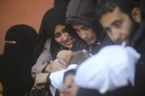 Palestinians mourn for relatives killed in the Israeli bombardment of the Gaza Strip. (Photo | AP)