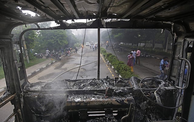 A fire brigade truck burnt by Dera Sacha Sauda sect members lies near Panchkula's court house. (AP)