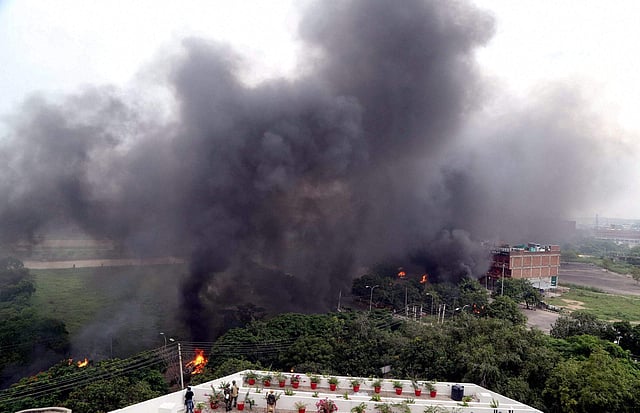 Black smoke rises over the skyline of Panchkula as vehicles burn in violence following Dera Sacha Sauda chief Gurmeet Ram Rahim s conviction in Panchkula on Friday. (PTI)