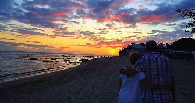 A leisurely stroll on the beach by sunset