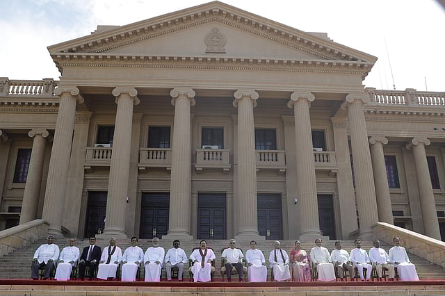Sri Lankan president Gotabaya Rajapaksa, seated center, sits for photographs with his new cabinet members in Colombo. (Photo | AP)