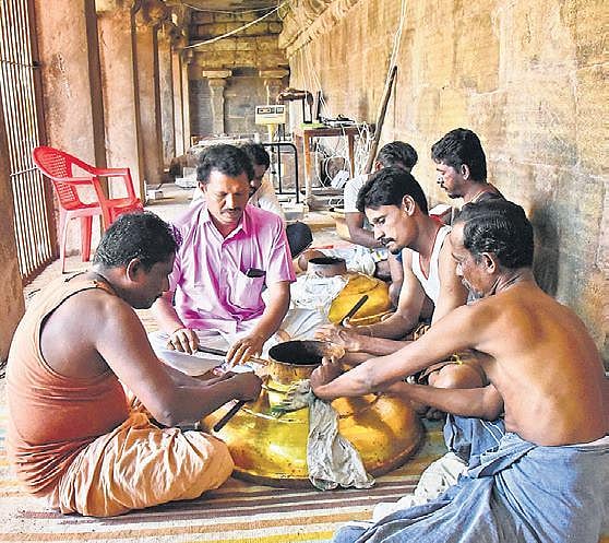 Workers handling parts of the kalasam