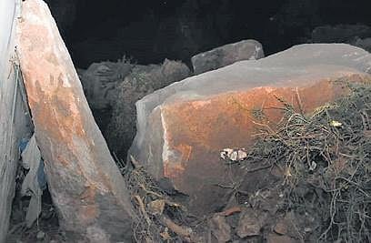 The boulders that fell beside a house.