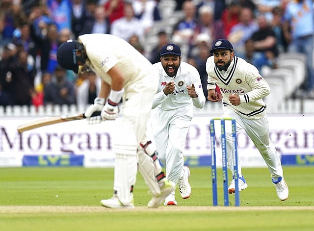 India's Virat Kohli, right, celebrates catching the ball to dismiss England's Joe Root during day five. (Photo | AP)
