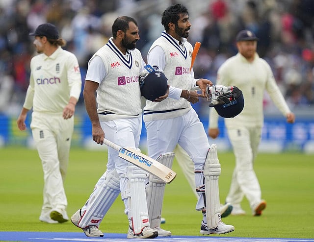 India's Mohdohammed Shami, left and India's Jasprit Bumrah walk off the pitch at then lunch interval during the fifth day. (Photo | AP)