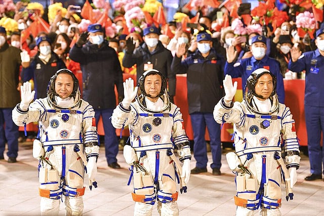 Chinese astronauts Fei Junlong, Deng Qingming and Zhang Lu wave as they attend a send-off ceremony ahead of the Shenzhou-15 manned space mission at the Jiuquan Satellite Launch Center in northwest China on Tuesday, Nov. 29, 2022 | AP