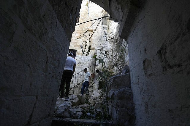 Palestinians inspect the damage to a house. (Photo | AP)