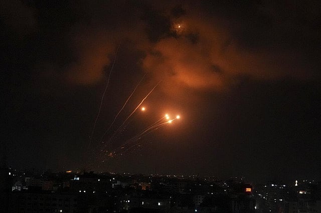 Rockets fired by Palestinian militants toward Israel are seen over Gaza City. (Photo | AP)