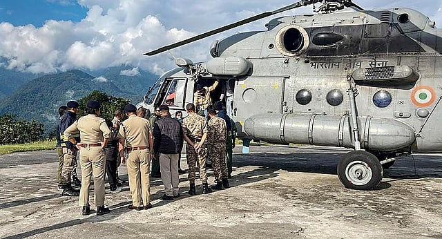 Tourists evacuated by the Indian Air Force from flood-affected Lachen arrive at Ringhim Helipad, Mangan in Sikkim | PTI