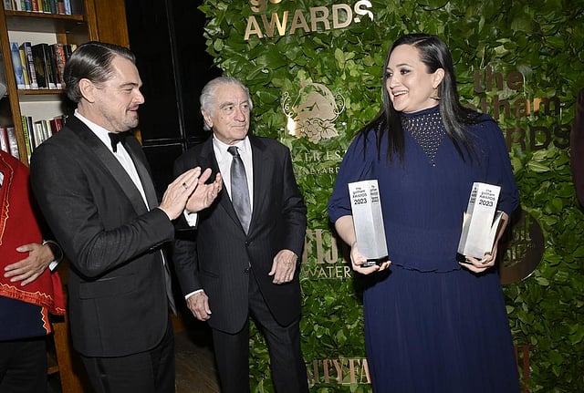 Leonardo DiCaprio, left, Robert De Niro and Lily Gladstone pose with the Gotham historical icon & creator tribute for