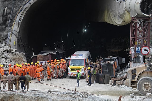 An ambulance waits to carry workers from the site. (AP)