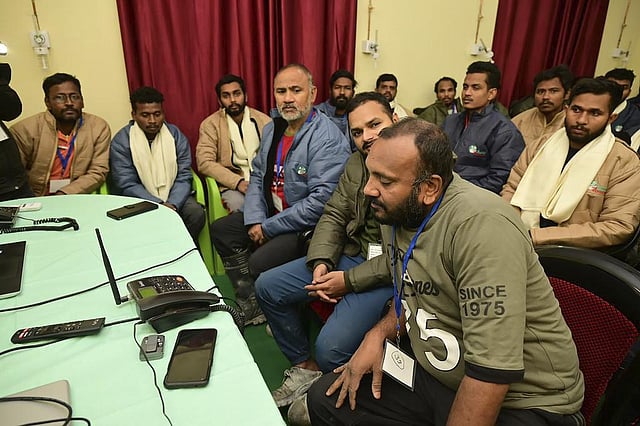 Workers sit for a phone call with PM Narendra Modi on Nov 28, 2023. (Uttarakhand DIPR)