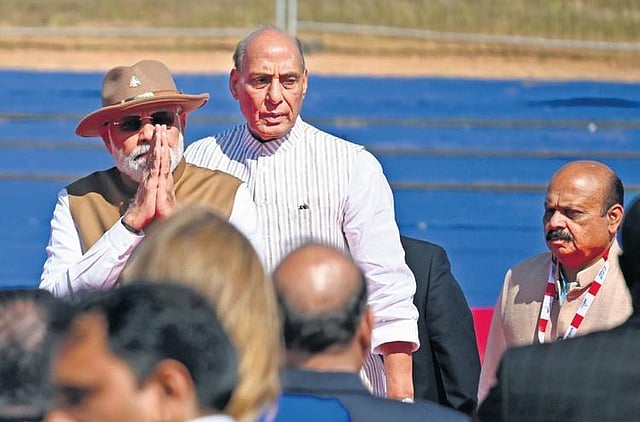 PM Narendra Modi greets the gathering at Aero India 2023 in Bengaluru on Monday. Defence Minister Rajnath Singh and CM Basavaraj Bommai look at |Shashidhar Byrappa