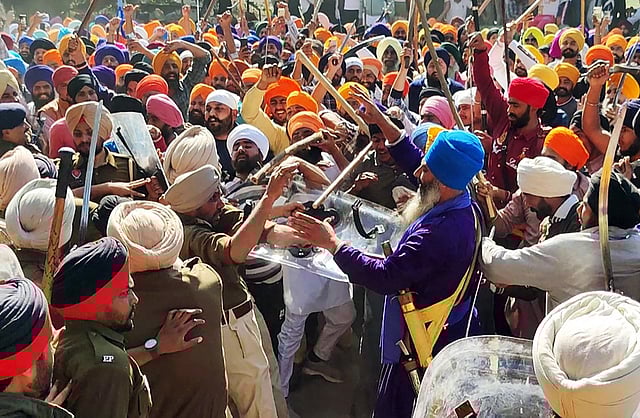 'Waris Punab De' group's leader Amritpal Singh's supporters break barricades and enter the police station demanding the release of Amritpal Singh's close aide, in Ajnala near Amritsar on Thursday. (Photo | ANI)
