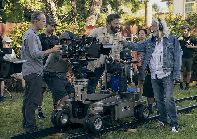 This image released by Amazon Prime Video shows director Ben Affleck, seated center, on the set of