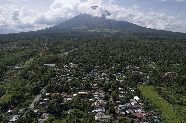 Homes are seen near the permanent danger zone surrounding the Mayon volcano at Bonga village, Albay province, northeastern Philippines, on June 15, 2023. (Photo | AP)