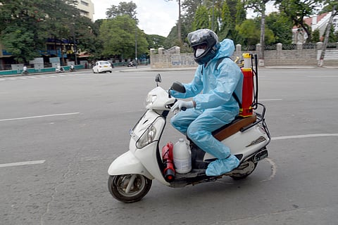 Safety first is the criteria for this man who was seen riding his bike in a PPE kit in Hudson Circle, Bengaluru. (Photo | Nagaraja Gadekal P, EPS)