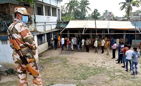 People stand in a queue to cast their votes during the 7th phase of West Bengal Assembly Polls in the Murshidabad district of West Bengal, Monday. (Photo | PTI)