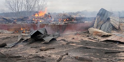 Smoke and flame rise from the debris of a privet house in the aftermath of Russian shelling outside Kyiv. (Photo | AP)
