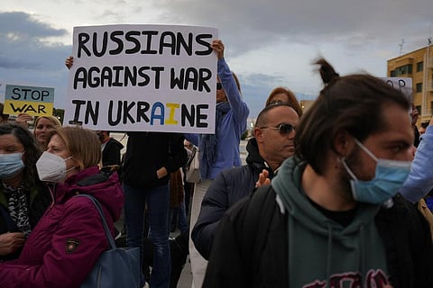 Protesters hold up a placard during a protest at Eleptheria, Liberty square in central Nicosia, Cyprus. (Photo | AP)