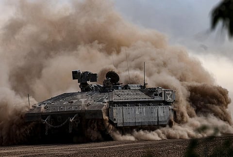 An Israeli armoured vehicle rolls in a field close to the border with the Gaza Strip on October 15, 2023, amid the ongoing battle between Israel and the Palestinian Islamist group Hamas. (Photo | AFP)