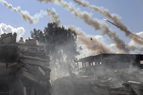 Rockets fly over destroyed buildings following Israeli airstrikes on Gaza City, central Gaza Strip, Thursday, Oct. 19, 2023. (Photo | AP)