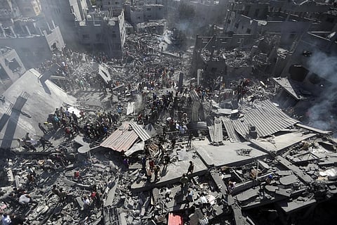Palestinians inspect the rubble of destroyed buildings following Israeli airstrikes on town of Khan Younis, southern Gaza Strip, Thursday, Oct. 26, 2023. (Photo | AP)