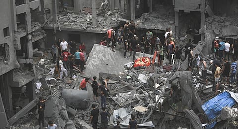 Palestinians inspect the damage of destroyed buildings following Israeli airstrikes on Gaza City, Friday, Oct. 27, 2023.(Photo | AP)
