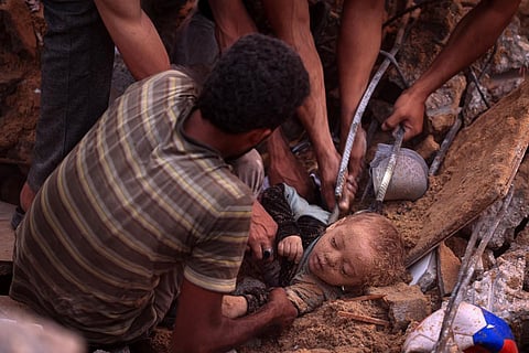 Palestinians dig out the body of a child from the rubble of a building in the Nuseirat refugee camp, in the central Gaza Strip on October 31, 2023, amid relentless Israeli bombardment. (Photo | AFP)