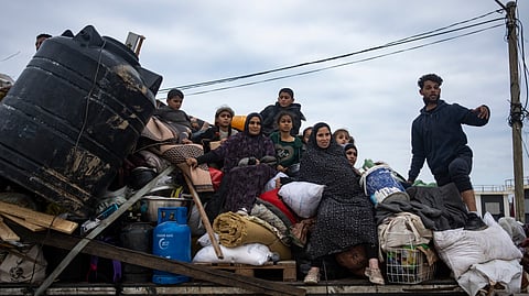 Palestinians arrive in the southern Gaza town of Rafah after fleeing an Israeli ground and air offensive in the nearby city of Khan Younis on Friday, Jan. 26, 2024.