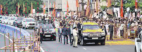 Public queued up on both sides of Sivananda Salai, showering flower petals on the Prime Minister's vehicle and waving party flags