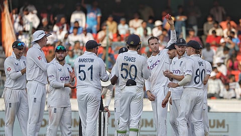 England players celebrate their victory against India in the first cricket test match in Hyderabad.