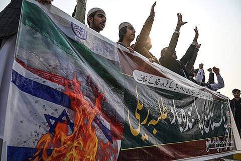 Youth activists of Muslim Talba Mahaz (MTM) holding a banner shout slogans during a protest against Iranian air strike, in Islamabad on January 18, 2024. 