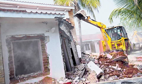 A JCB demolishes a house belonging to BJP MLA KV Ramana Reddy after he decided to set an example by allowing the razing in public interest, in Kamareddy on Friday  