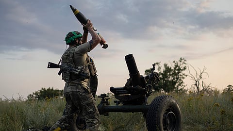 A Ukrainian serviceman of the 3rd Assault Brigade fires a 122mm mortar towards Russian positions at the front line, near Bakhmut, Donetsk region, Ukraine, Sunday, July 2, 2023.