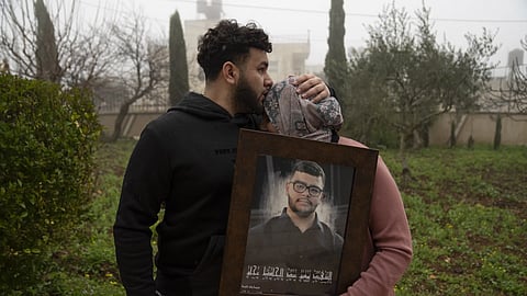 Amir Abdel Jabbar, whose younger brother Tawfiq was fatally shot, comforts their mother Mona, at West Bank, Tuesday, Jan 23, 2024.