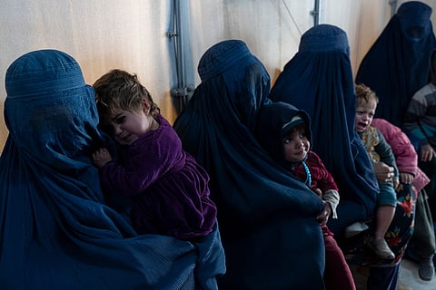Afghan burqa-clad women and children refugees deported from Pakistan, in a nutrition ward at the United Nations High Commissioner for Refugees (UNHCR) camp on the outskirts of Kabul, on Jan 9, 2024. 