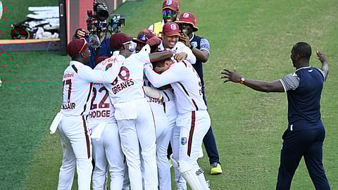 West Indies players celebrate after defeating Australia on the 4th day of their cricket test match in Brisbane, Sunday, Jan. 28, 2024.