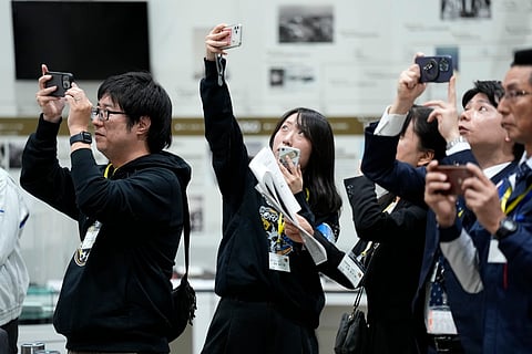 Staff of Japan Aerospace Exploration Agency (JAXA) watch a live streaming of the pinpoint moon landing operation by the Smart Lander for Investigating Moon (SLIM) spacecraft