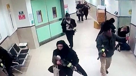 Israeli forces disguised as civilian women and medical workers hold weapons in a hallway at the Ibn Sina Hospital in the West Bank town of Jenin, Tuesday, jan 30, 2024, in the occupied West Bank
