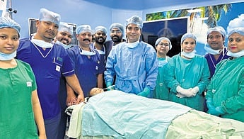 The baby with a team of surgeons led by  Dr Radhamadhab Sahu.